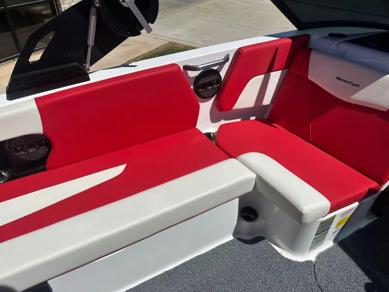 Slide: The Image of 2023 MasterCraft NXT22 boat interior with red and white seating. - 11