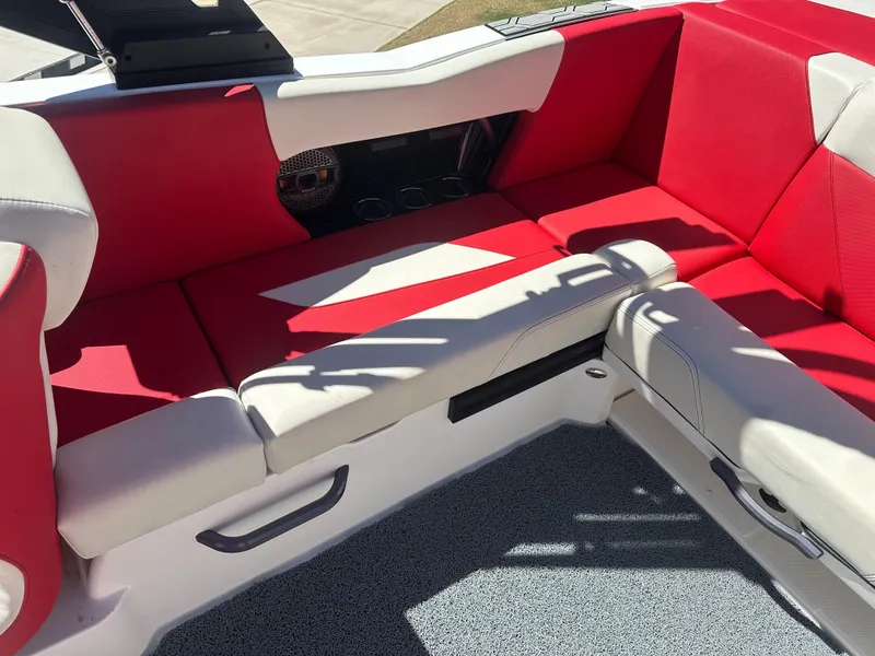 Slide: The Image of 2023 MasterCraft NXT22 boat interior with red and white seating. - 13