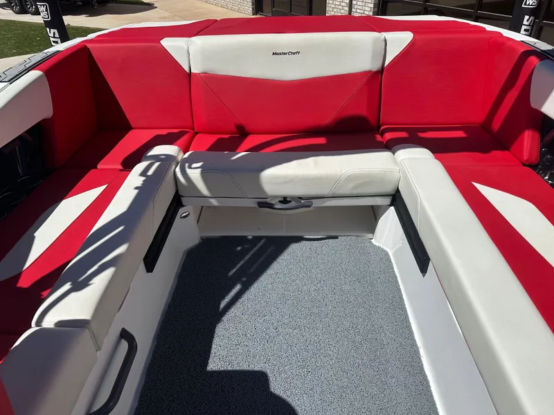 Slide: The Image of 2023 MasterCraft NXT22 boat interior with red and white seating. - 14