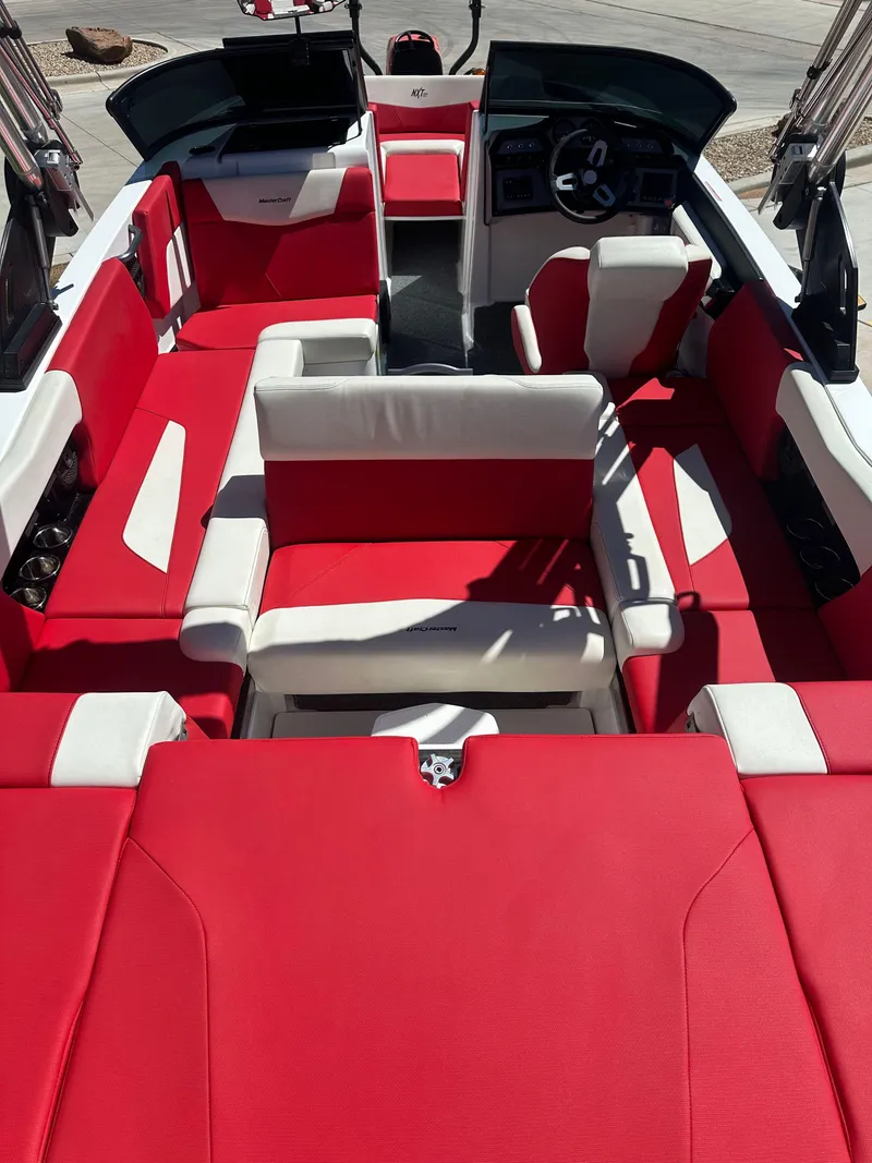 Slide: The Image of 2023 MasterCraft NXT22 boat interior with red and white seating. - 15