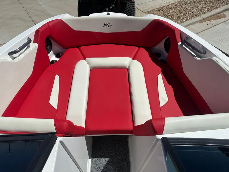 Slide: The Image of 2023 MasterCraft NXT22 boat interior with red and white seating. - 6