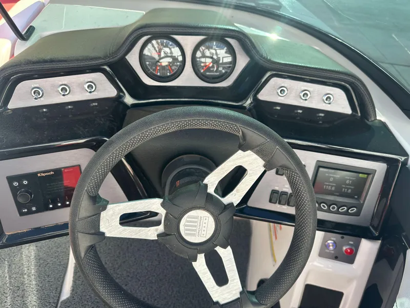 Slide: The Image of 2023 MasterCraft NXT22 dashboard with steering wheel, gauges, and control panel. - 8