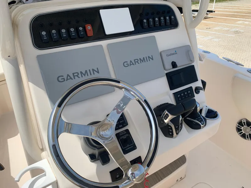 Slide: The Image of 2024 Grady-White 257 Fisherman boat console with Garmin navigation and steering wheel. - 10