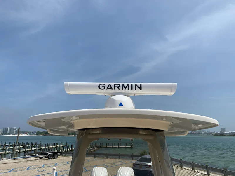 Slide: The Image of 2024 Grady-White 257 Fisherman boat with Garmin radar, docked by the waterfront. - 11