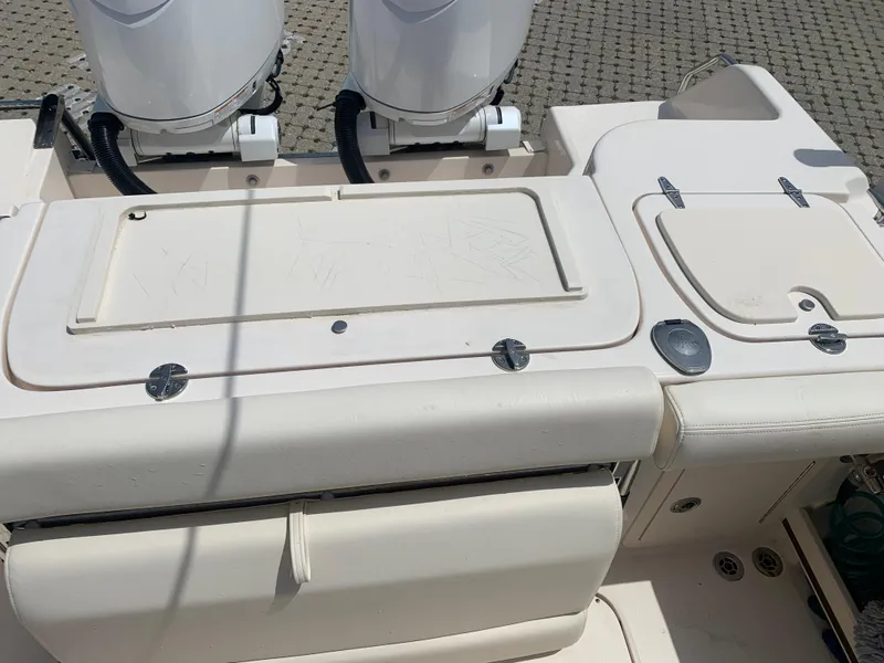 Slide: The Image of 2024 Grady-White 257 Fisherman boat deck with dual engines and storage compartments. - 12