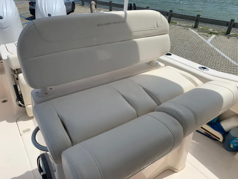 Slide: The Image of 2024 Grady-White 257 Fisherman boat seat, beige upholstery, dockside view. - 17