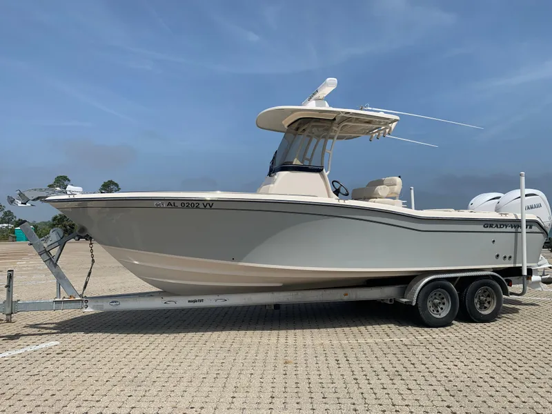 Slide: The Image of 2024 Grady-White 257 Fisherman boat on trailer, parked outdoors under clear sky. - 2