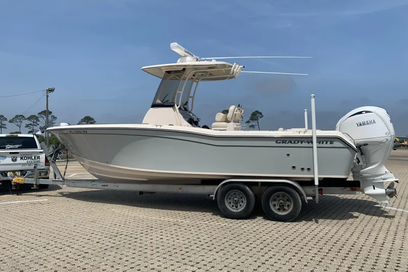 Slide: The Image of 2024 Grady-White 257 Fisherman boat on trailer, parked outdoors with clear sky. - 3