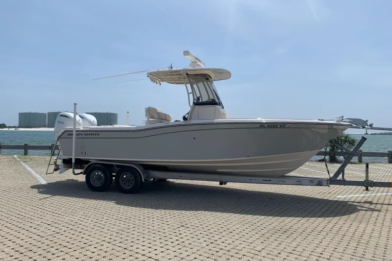 Slide: The Image of 2024 Grady-White 257 Fisherman boat on trailer by waterfront, clear sky background. - 4