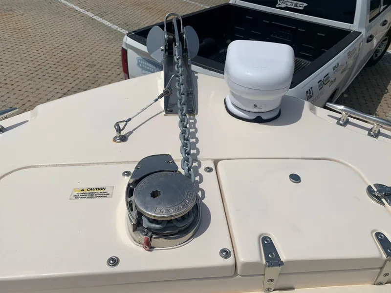 Slide: The Image of 2024 Grady-White 257 Fisherman boat anchor system on deck, parked near a truck. - 7
