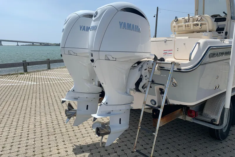 Slide: The Image of 2024 Grady-White 257 Fisherman boat with dual Yamaha outboard motors docked by the water. - 8