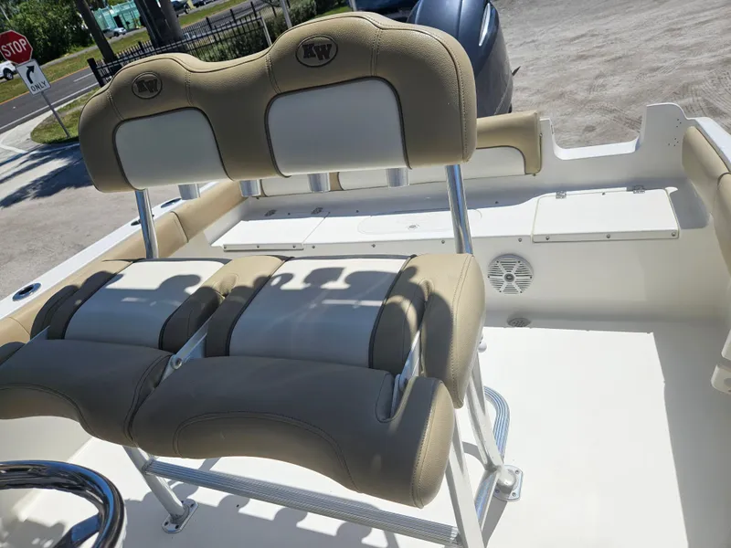 Slide: The Image of 2018 Key West 219 FS boat seating with beige and white cushioned seats. - 12