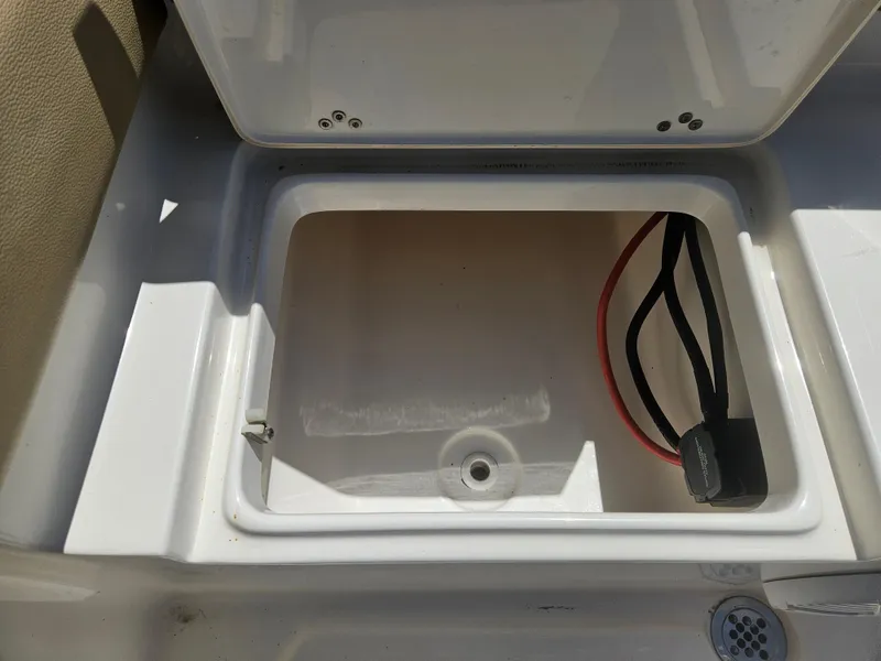 Slide: The Image of Open storage compartment on 2018 Key West 219 FS boat with visible wiring. - 17