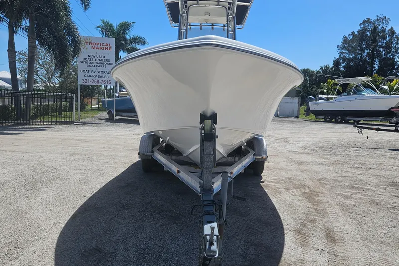 Slide: The Image of 2018 Key West 219 FS boat on trailer, parked outdoors under clear sky. - 21