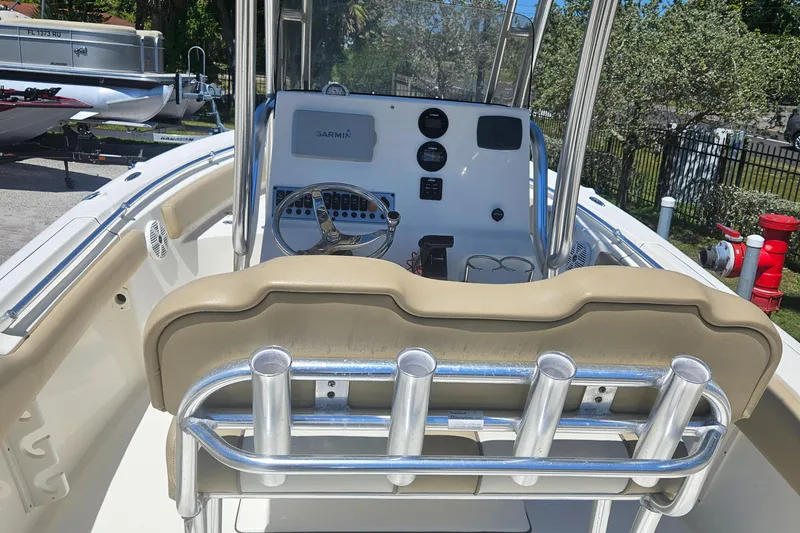 Slide: The Image of 2018 Key West 219 FS boat interior with steering console and rod holders. - 22