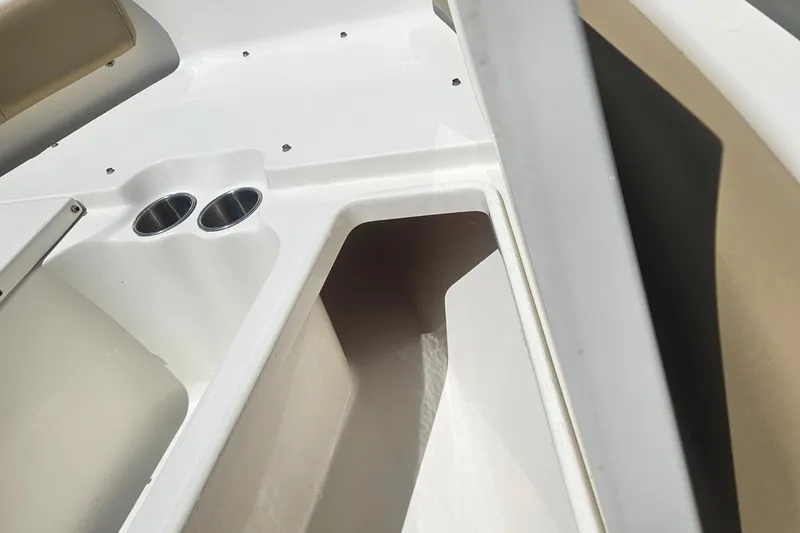 Slide: The Image of 2018 Key West 219 FS boat interior with cup holders and storage compartment. - 25
