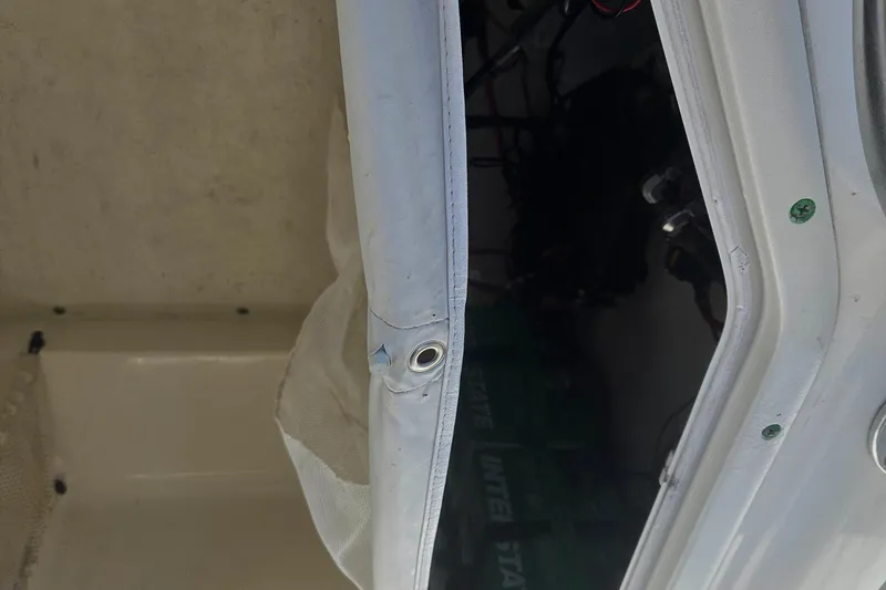 Slide: The Image of 2018 Key West 219 FS boat interior with storage compartment and visible battery. - 27