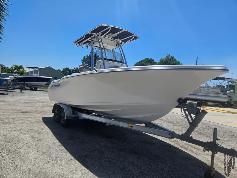 Slide: The Image of 2018 Key West 219 FS boat on trailer under clear blue sky. - 3