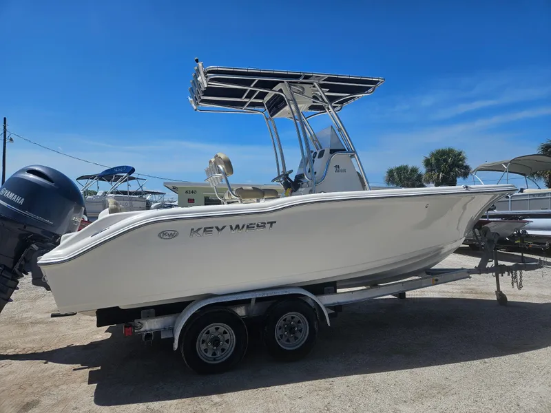 Slide: The Image of 2018 Key West 219 FS boat on trailer, featuring Yamaha outboard motor, under clear blue sky. - 5