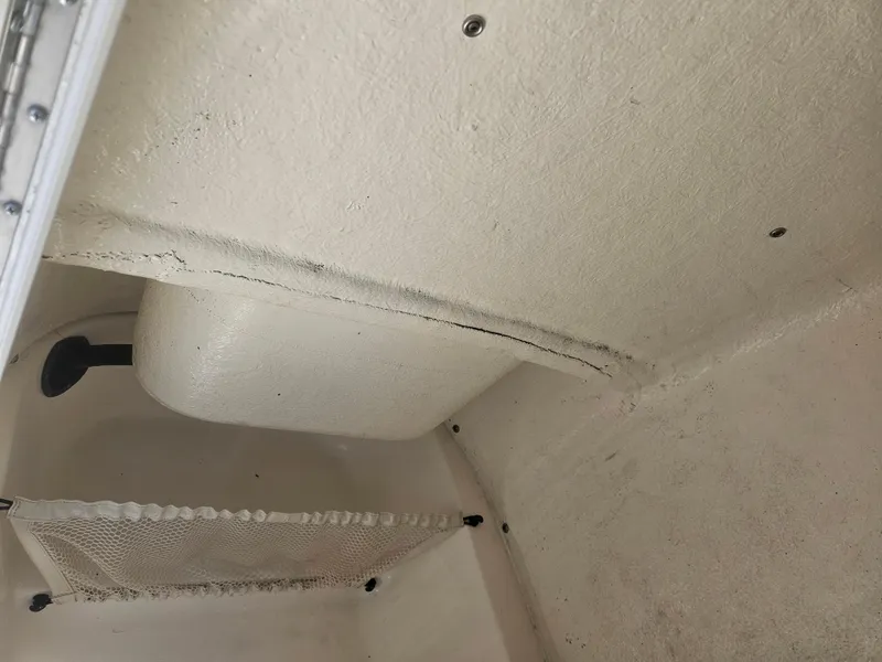 Slide: The Image of 2018 Key West 219 FS boat interior storage compartment with netting and white finish. - 9