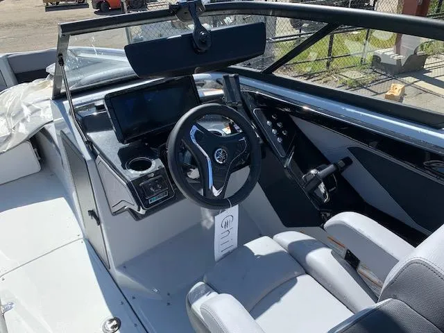Slide: The Image of 2025 Yamaha Boats 255XD cockpit with steering wheel and control panel. - 12