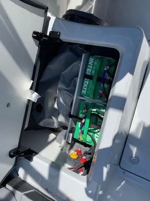 Slide: The Image of 2025 Yamaha Boats 255XD battery compartment with Interstate batteries visible. - 13