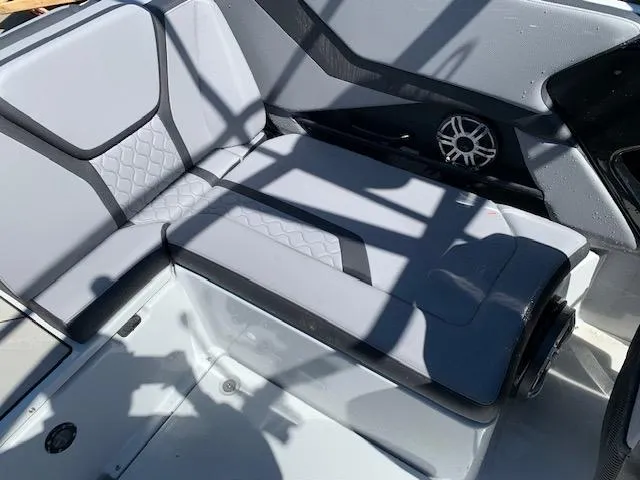 Slide: The Image of 2025 Yamaha Boats 255XD interior seating with modern design and speaker detail. - 14