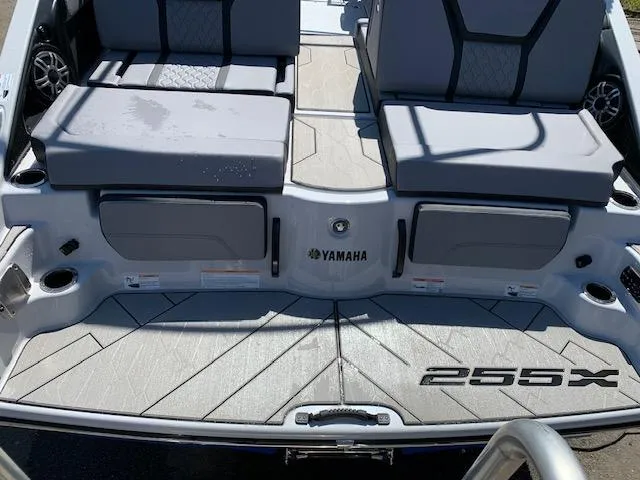 Slide: The Image of 2025 Yamaha Boats 255XD rear seating and deck, featuring sleek design and branding. - 27