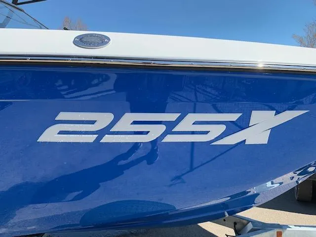 Slide: The Image of 2025 Yamaha Boats 255XD, blue hull with bold "255X" lettering. - 3
