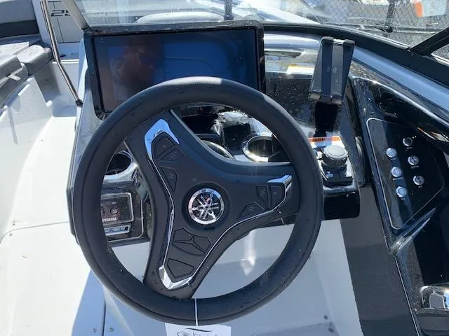 Slide: The Image of Steering wheel and dashboard of 2025 Yamaha Boats 255XD, featuring modern controls and display. - 5