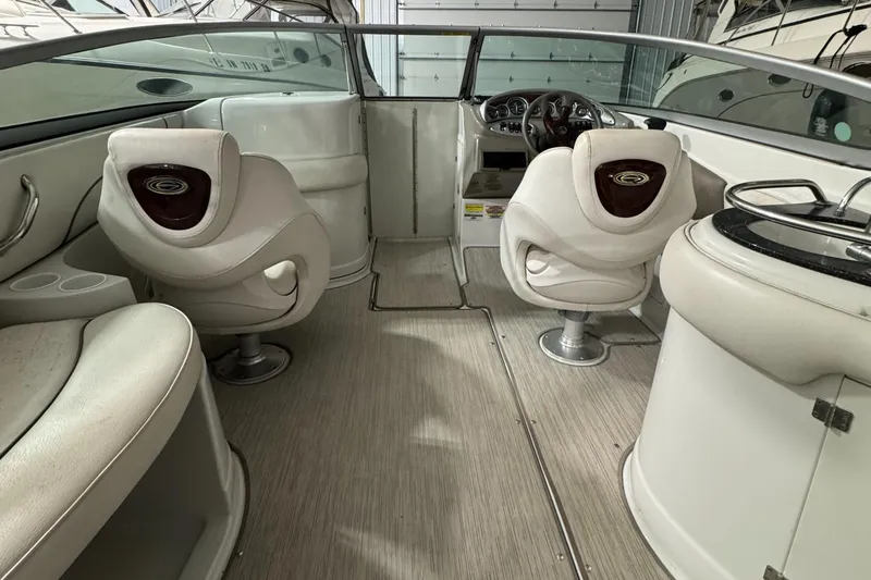 Slide: The Image of 2005 Crownline 240 EX boat interior with plush seating and modern dashboard. - 15