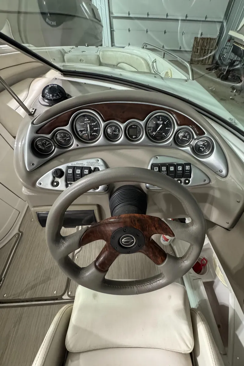 Slide: The Image of 2005 Crownline 240 EX boat dashboard with steering wheel and instrument panel. - 4
