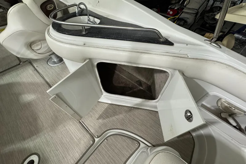 Slide: The Image of 2005 Crownline 240 EX boat interior with open storage compartment. - 7
