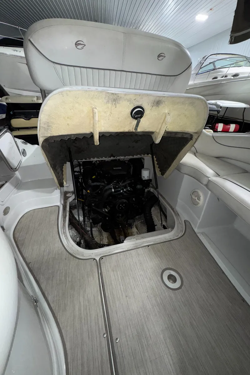 Slide: The Image of 2005 Crownline 240 EX boat engine compartment with open hatch, showcasing interior details. - 9