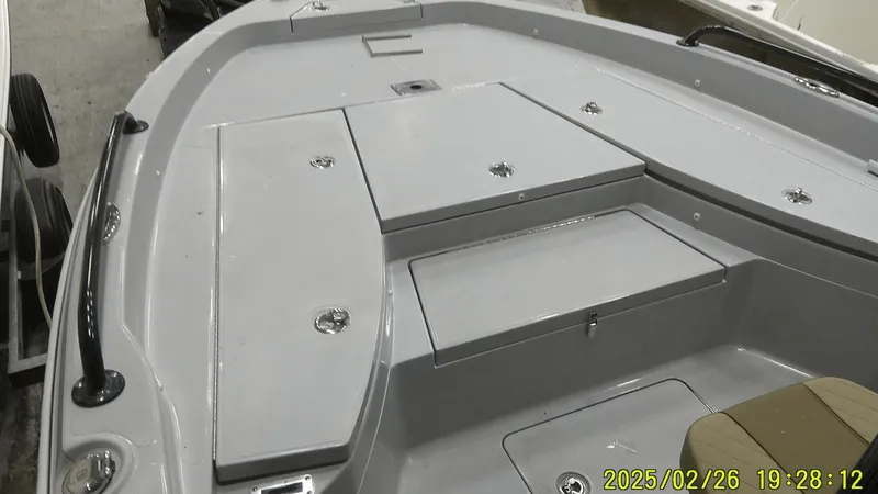 Slide: The Image of 2024 Ranger 2510 Bay boat interior with storage compartments and seating. - 11