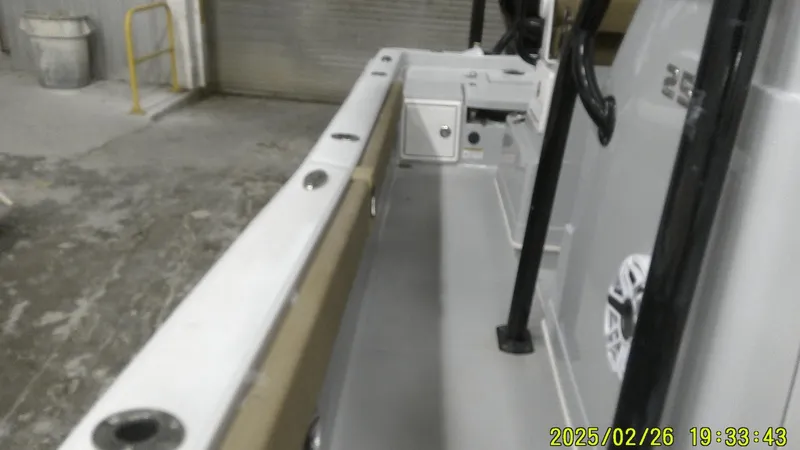 Slide: The Image of 2024 Ranger 2510 Bay boat interior, showcasing deck and storage compartments. - 12