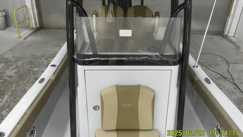 Slide: The Image of 2024 Ranger 2510 Bay boat interior with beige seating and console, timestamped February 26, 2025. - 14