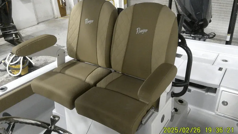 Slide: The Image of 2024 Ranger 2510 Bay boat seats, brown upholstery, dual seating, armrests, steering wheel visible. - 3