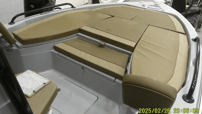 Slide: The Image of 2024 Ranger 2510 Bay boat interior with tan cushioned seating. - 5