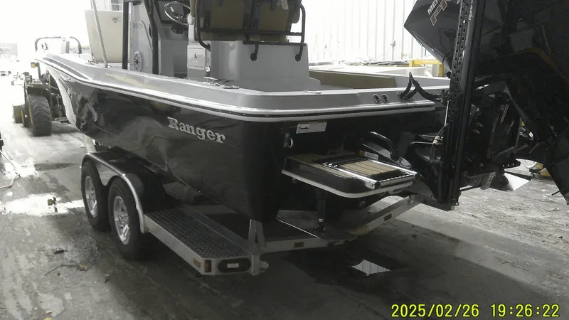 Slide: The Image of 2024 Ranger 2510 Bay boat on trailer in a garage setting. - 7