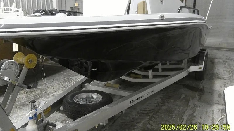 Slide: The Image of 2024 Ranger 2510 Bay boat on trailer in a storage facility. - 9
