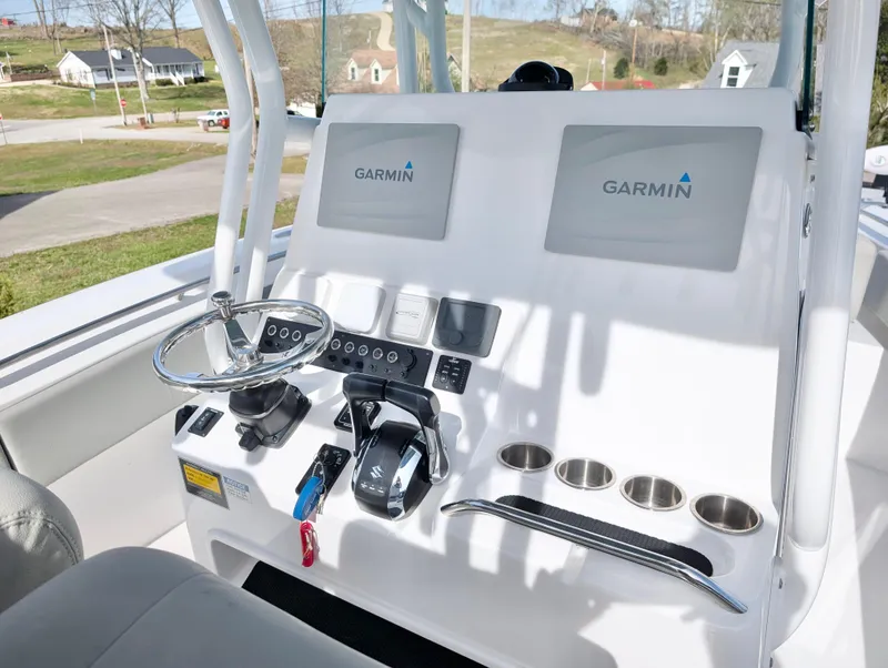 Slide: The Image of 2023 Cape Horn 32 XS boat console with Garmin displays and steering wheel. - 11