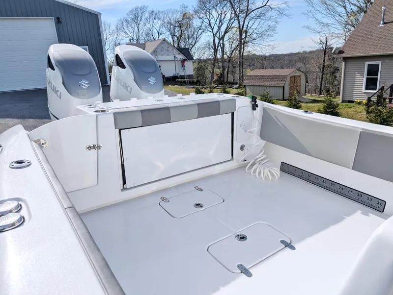 Slide: The Image of 2023 Cape Horn 32 XS boat deck with dual engines, spacious layout, and storage compartments. - 13