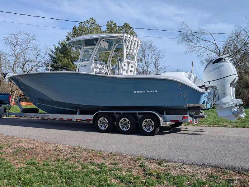 Slide: The Image of 2023 Cape Horn 32 XS boat on trailer, side view, outdoors. - 2