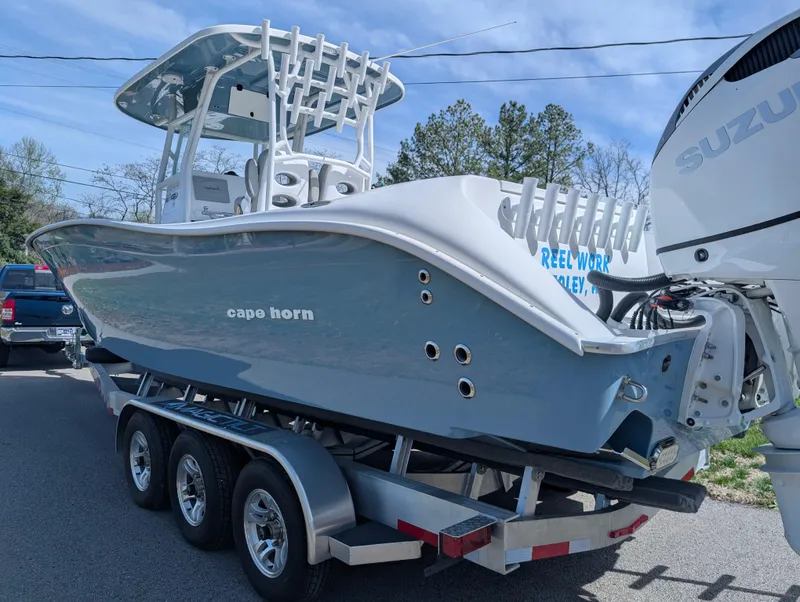 Slide: The Image of 2023 Cape Horn 32 XS boat on trailer with Suzuki outboard motor. - 3