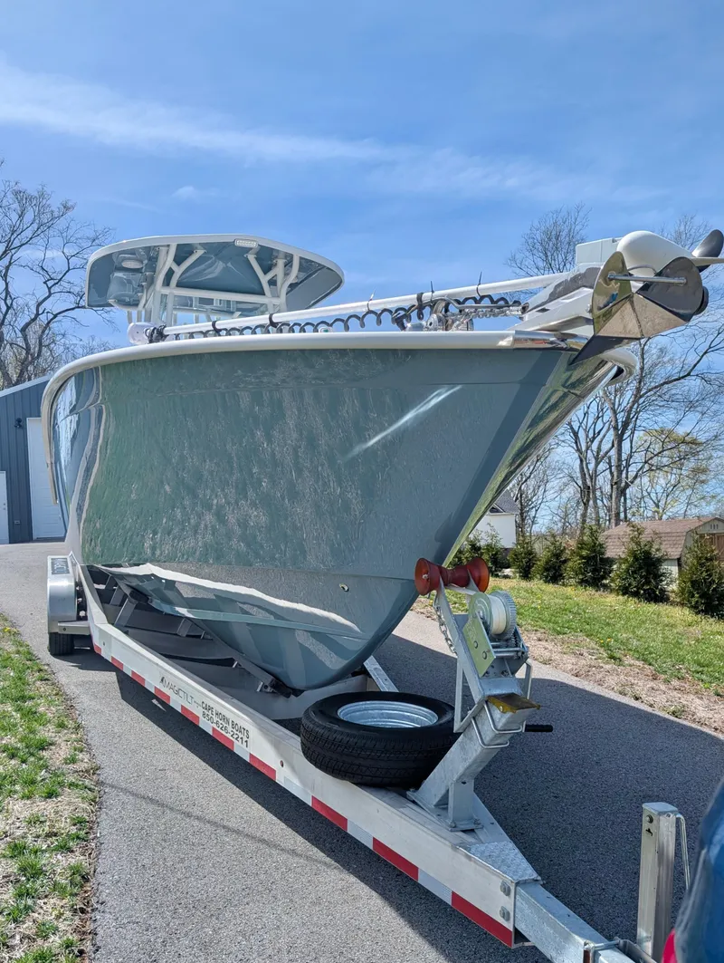Slide: The Image of 2023 Cape Horn 32 XS boat on trailer, parked outdoors under clear sky. - 5