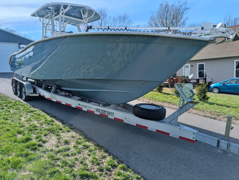 Slide: The Image of 2023 Cape Horn 32 XS boat on a trailer, parked outdoors. - 6