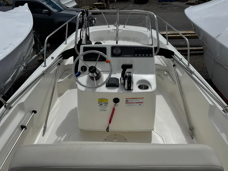 Slide: The Image of 2023 Boston Whaler 170 Montauk boat interior with steering console and controls. - 12
