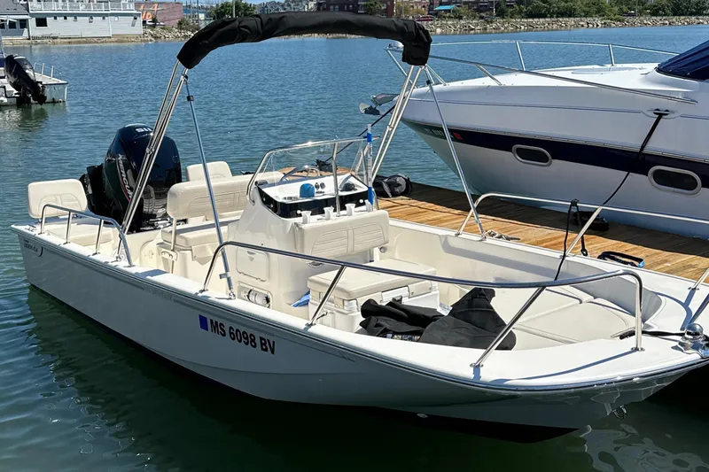 Slide: The Image of 2023 Boston Whaler 170 Montauk boat docked in a marina. - 16