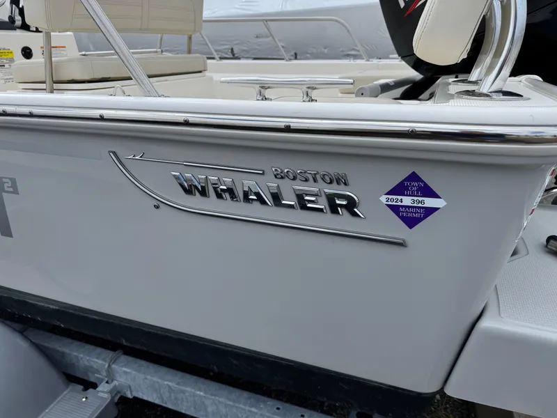 Slide: The Image of 2023 Boston Whaler 170 Montauk boat side view with logo and registration sticker. - 20